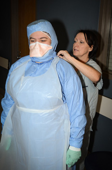 Allison White, Director of Clinical Programs, and Denise Ouellet, Infection Prevention and Control Nurse at the Dr. Georges-L.-Dumont UHC, demonstrating the personal protective equipment used by caregivers. 
