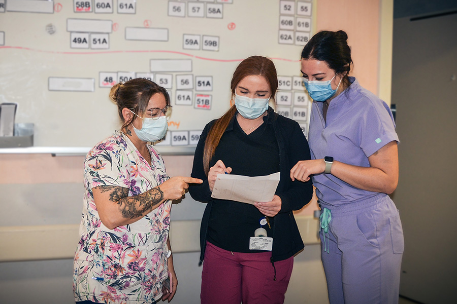 Pictured are three Campbellton Regional Hospital employees talking at the beginning of a shift.  From left to right: Annick Thériault, Patient Care Attendant, MacKenzie Cooling, Licensed Practical Nurse and Marie-Pier Martel, Registered Nurse.
